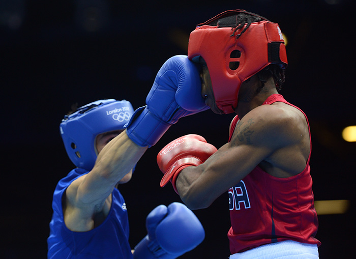 Photo of Nordine Oubaali and Raushee Warren boxing.